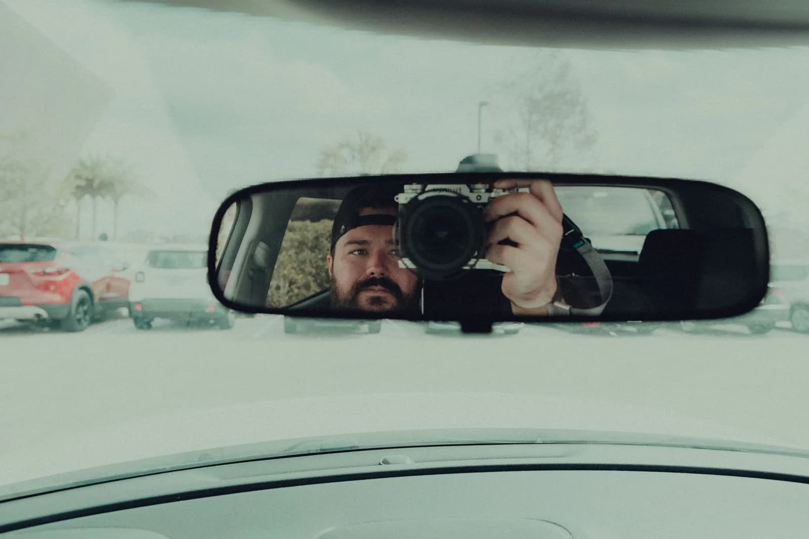 A dash cam mounted to the windshield of a commercial vehicle facing the road