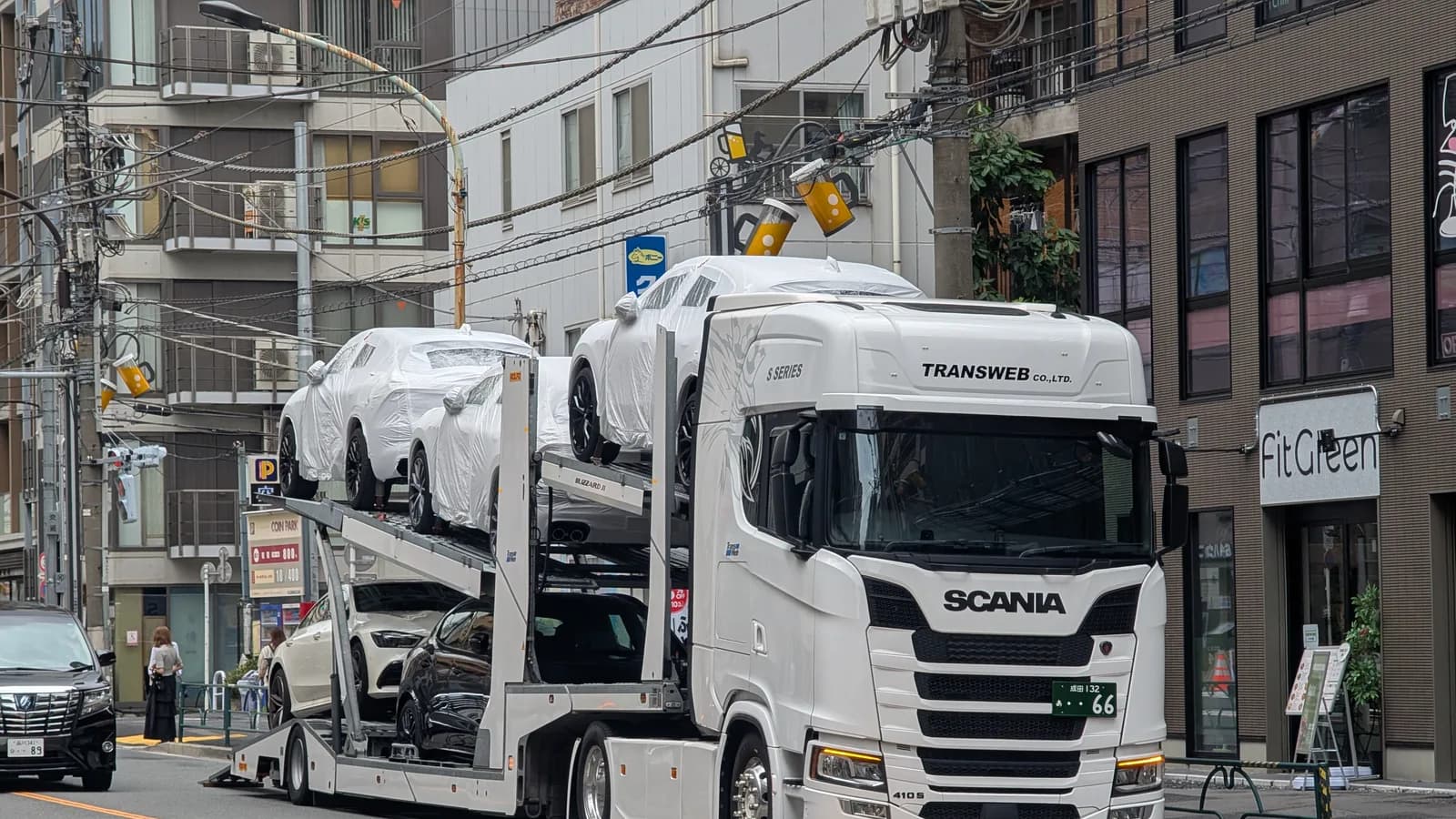 A car carrier truck loaded with vehicles on a city street