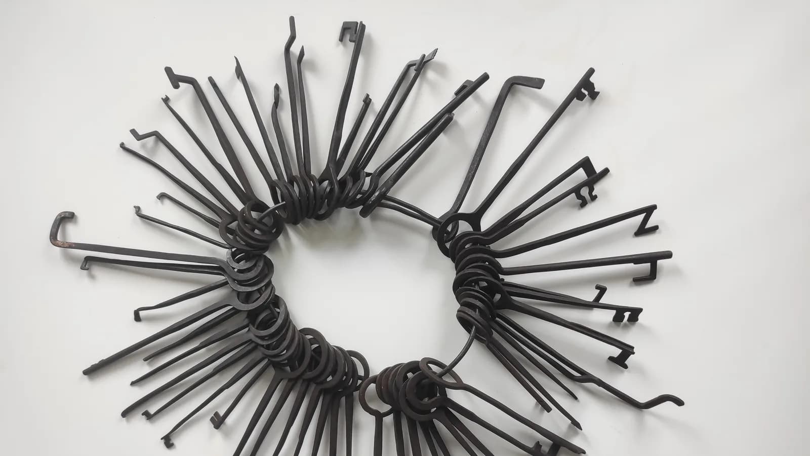 A ring of keys laid out on a white surface