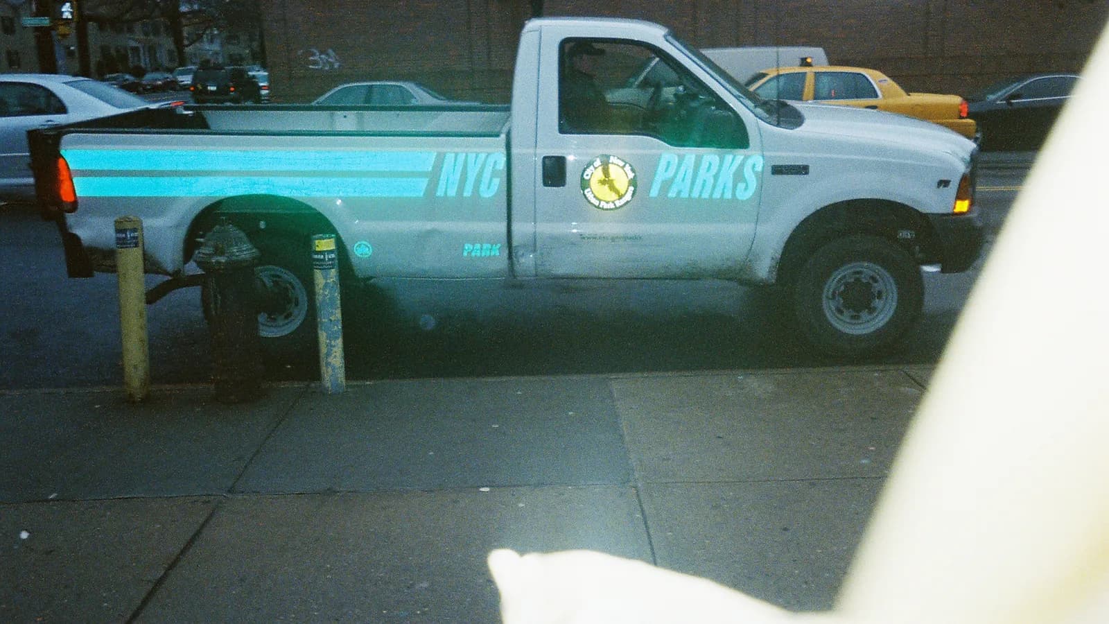 A parks department pickup truck parked beside a lawn