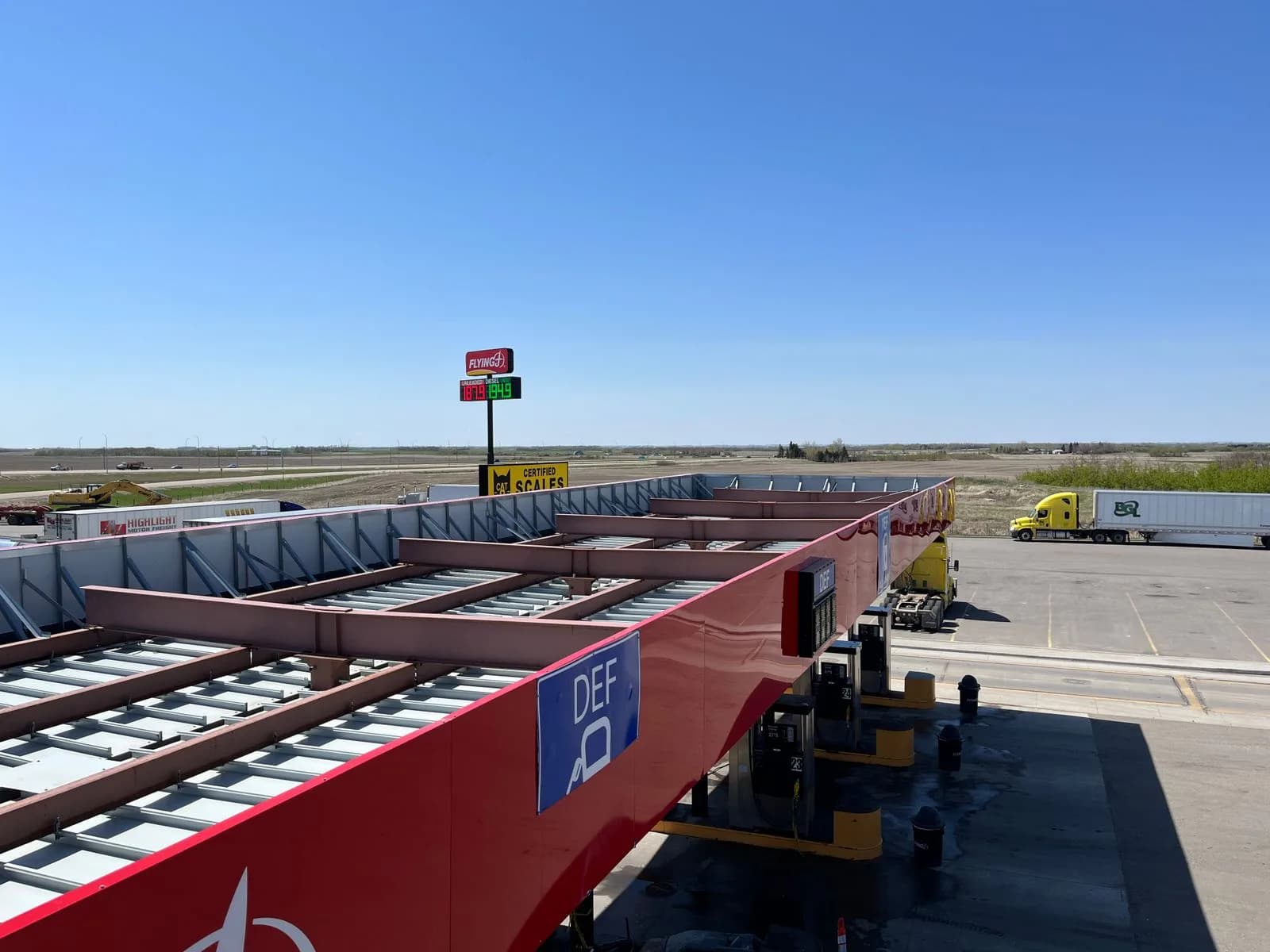 Vue aérienne d'un relais routier avec un îlot de carburant et une balance certifiée pour camions