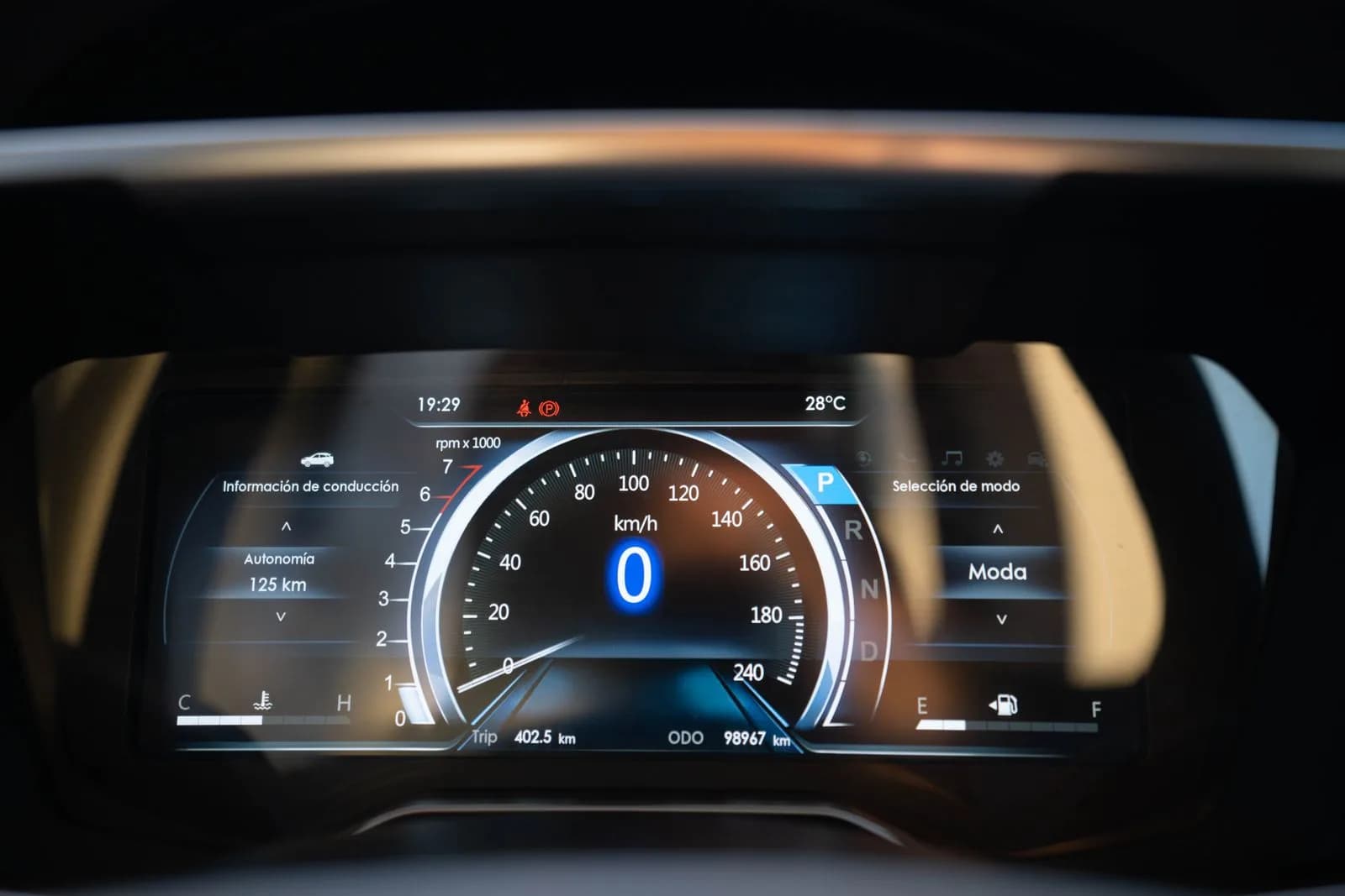 A close-up of a digital vehicle dashboard display