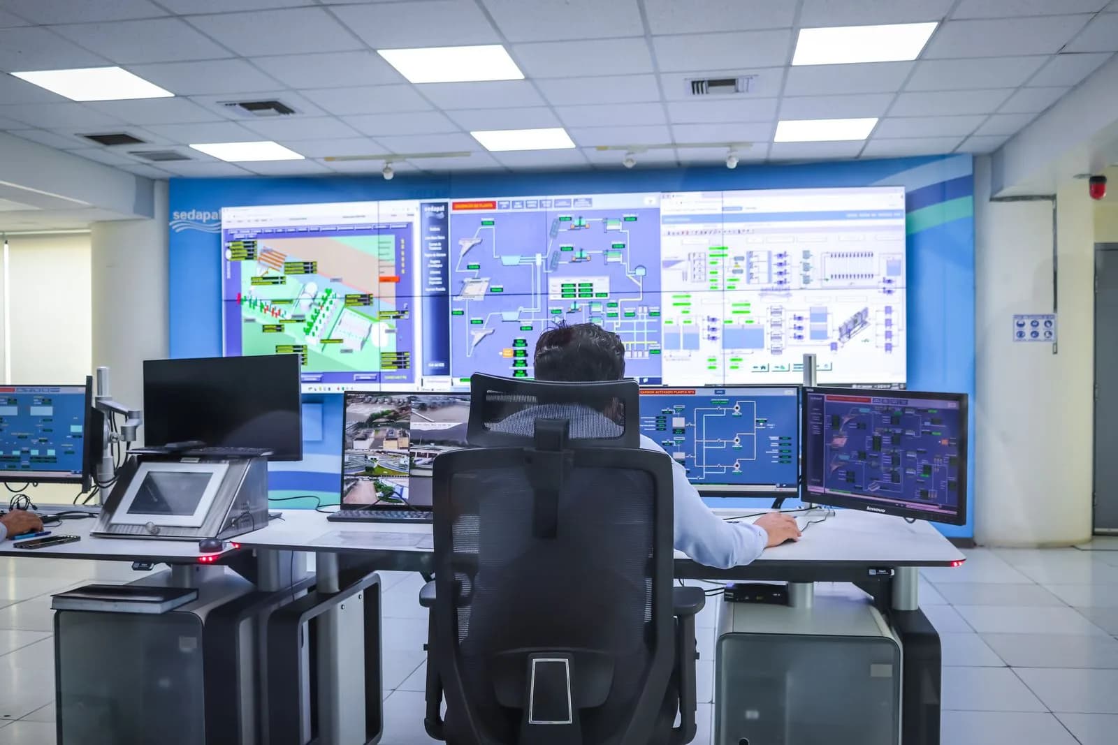 A fleet manager reviewing paperwork at a computer