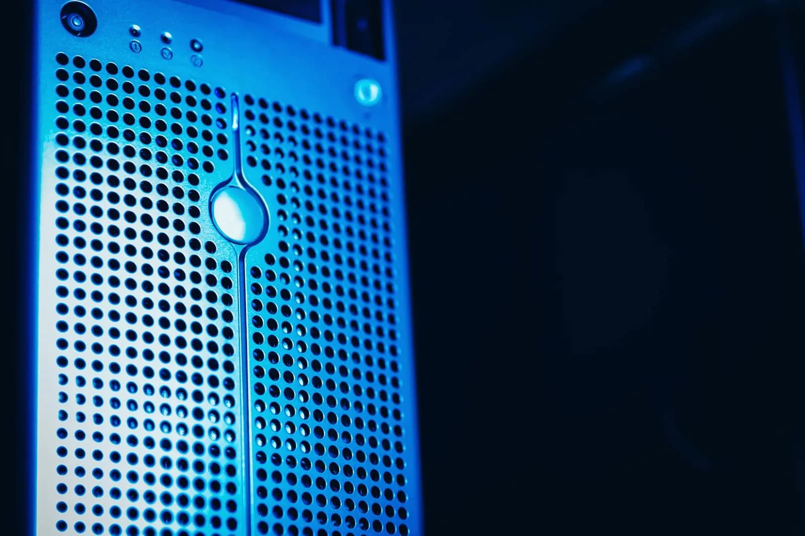A modern server rack illuminated by blue lighting in a data center