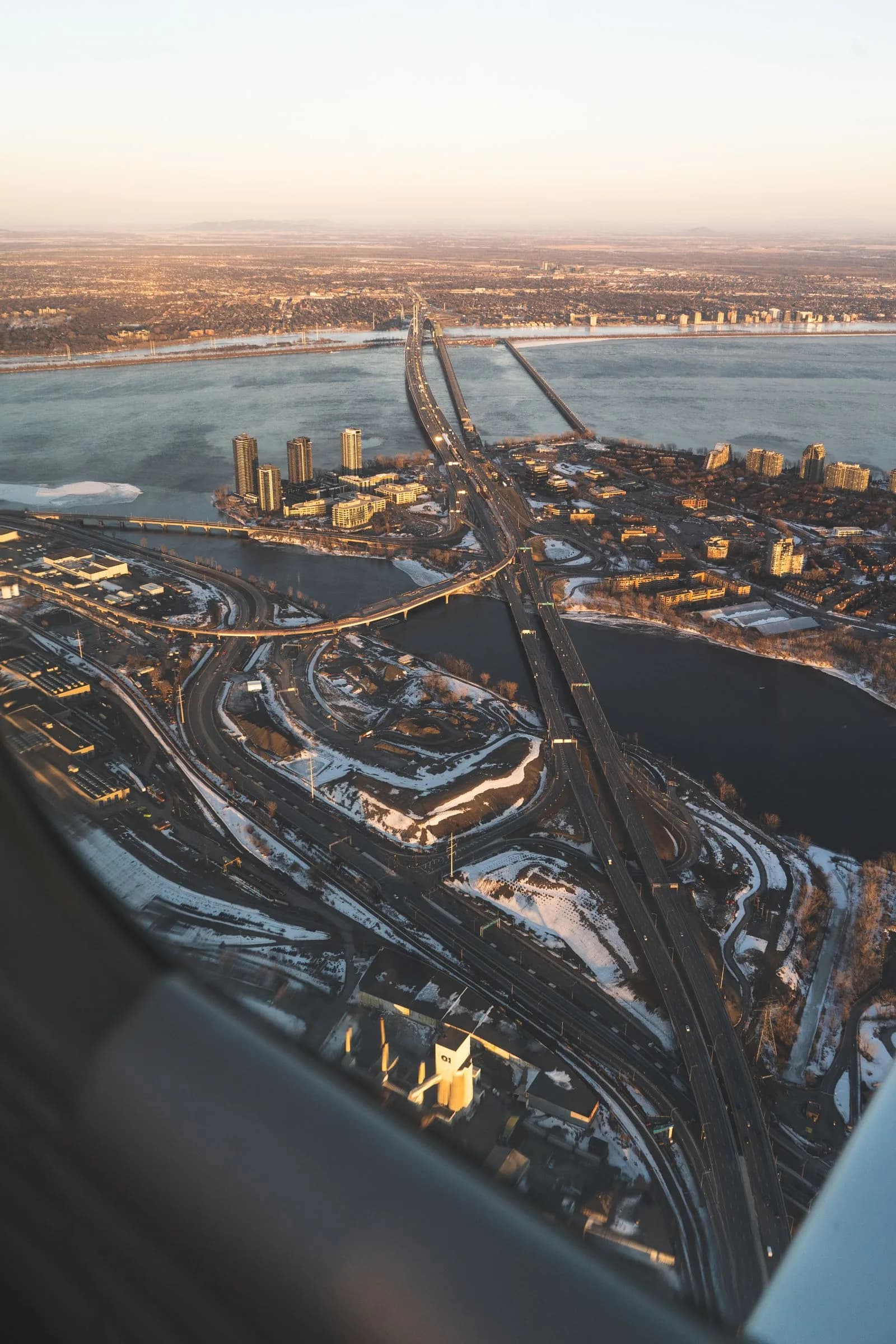 Aerial view of Montreal's highway bridges over a frozen river in winter