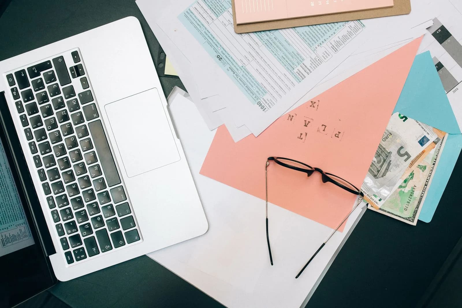 A fleet manager filing a quarterly tax return on a laptop at a desk